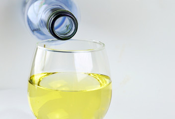  Bottle of white wine glass being poured in a glass isolated