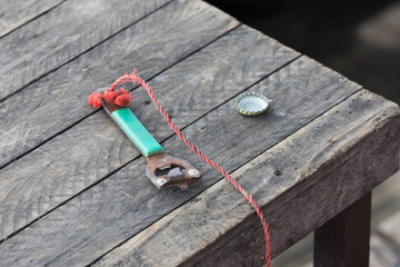 old can opener on a wooden table