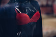 Lingerie store. Red female bra on a black mannequin in lingerie store. Shopping concept