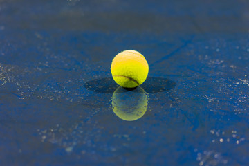 Wall Mural - Tennis ball with reflection on ground after raining