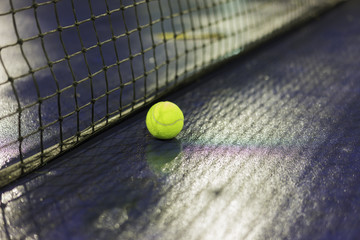 Wall Mural - Tennis ball and net on wet ground after raining