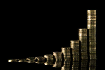 Stack Of Coins Over Black Background