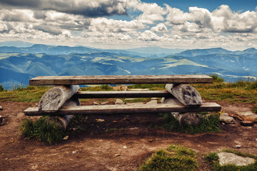 Wooden table and bench for relaxation on the top of Pip Ivan mountain, nature landscape in Carpathians, Ukraine.