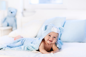 Wall Mural - Baby in towel after bath in bed