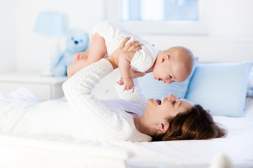 Wall Mural - Baby and mother at home. Mom and child.