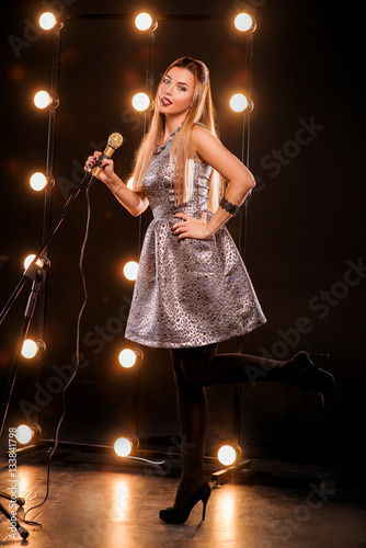 Young Smiley Beautiful Long Hair Girl With Microphone Singing Song
