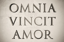 Latin Quote "Omnia Vincit Amor" On Stone Background, 3d Illustration - Meaning "Love Conquers All"