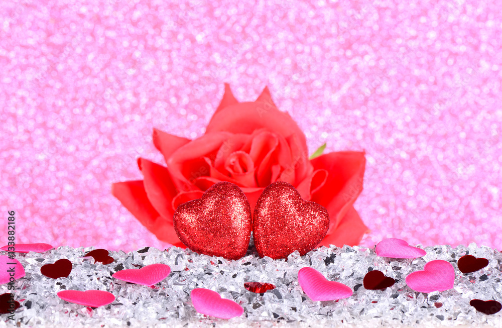 The red heart shapes and red rose flower on abstract light pink glitter ...