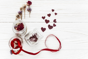 Wall Mural - stylish hearts in glass jar and roses and ribbons on white woode