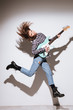 © Drobot Dean - Lady holding guitar and jumping