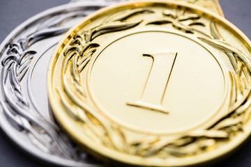 Close-up of golden medal with embossed number one