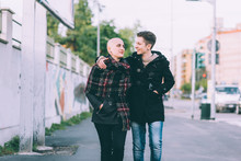 Young Lesbian Couple Strolling Along City Street