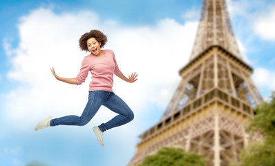 Wall Mural - happy african american woman jumping over white