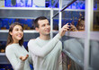 © JackF - Cheerful smiling customers selecting tropical fish
