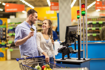 Sticker - couple buying food at grocery at cash register