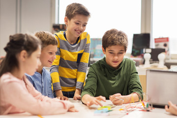 Wall Mural - happy children building robots at robotics school