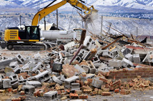 Heavy Equipment Tearing Down Building Construction