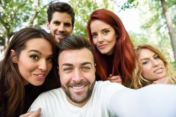 Wall Mural - Group of friends taking selfie in urban background