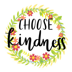 choose kindness handwriting message over wreath of flowers background