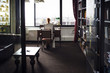 © Cavan Images - Rear view of businesswoman working at desk in creative office