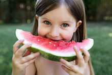 Portrait Of Cute Girl Eating Watermelon Slice