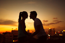 Young Couple Kissing At Twilight. 