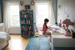 © Cavan Images - Girl sitting by table and making greeting card in bedroom