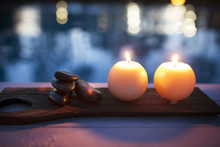 High Angle View Of Illuminated Candles And Stones On Table At Health Spa
