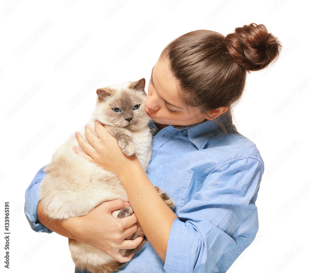 Beautiful young woman with cute cat on light background