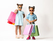 © Africa Studio - Two cute African girls with shopping bags on white background