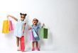 © Africa Studio - Two cute African girls with shopping bags on white background