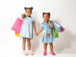 © Africa Studio - Two cute African girls with shopping bags on white background