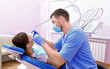 © Africa Studio - Dentist drilling patient's teeth in clinic