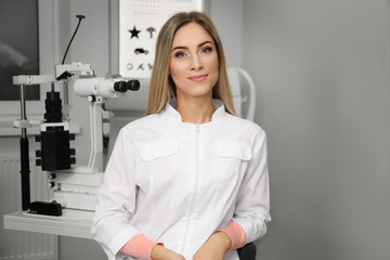 Beautiful young ophthalmologist in clinic