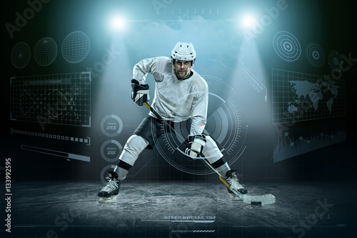 Fototapeta na szkło Ice hockey player on the ice around modern light