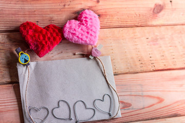 Wall Mural - Paper for your text and small red hearts on old wood background.