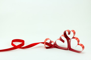 Ribbons shaped as hearts on white background, valentine day conc