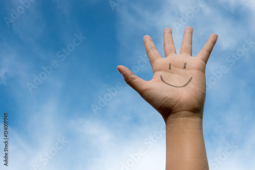 Photographie  Happy smiling face on hand with a good feeling