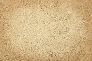 Top view of sandy beach. Background with copy space and visible sand texture.