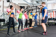 © Kzenon - Men and women with coach at kettlebell functional training