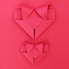 Poster - two folding red paper hearts on red for pattern and background