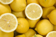 Background of lemons with some cut lemons