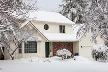 Residential Home.  Average American Two Story Residential Home Covered With Snow During Winter Storm.