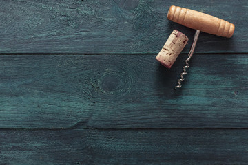 Wall Mural - Photo of wine corkscrew and cork on dark background