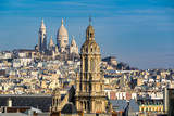Fototapeta  - Rooftops of Paris with view of the Sacre Coeur Basilica in Montmartre and the Trinity Church. 18th Arrondissement, Paris, France