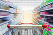 © nonnie192 - Supermarket aisle with empty red shopping cart