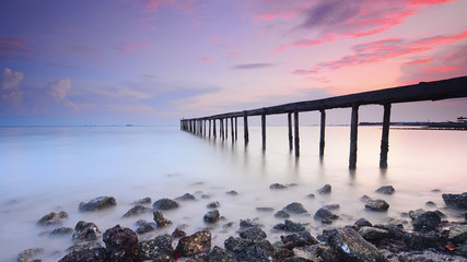 Canvas Print - Long exposure shot of old broken jetty during pastel sunset.