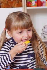 Wall Mural - Three-year girl playing and learning in preschool