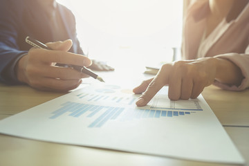 Business concept. Business people discussing the charts and graphs showing the results of their successful teamwork.