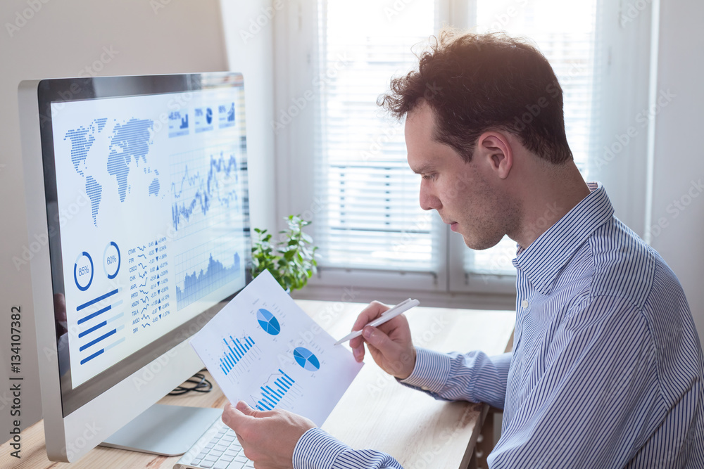 Investor analyzing financial reports and key performance indicators ...